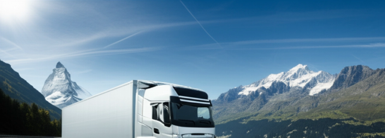 Modern moving truck traveling on a scenic highway with the Swiss Alps.